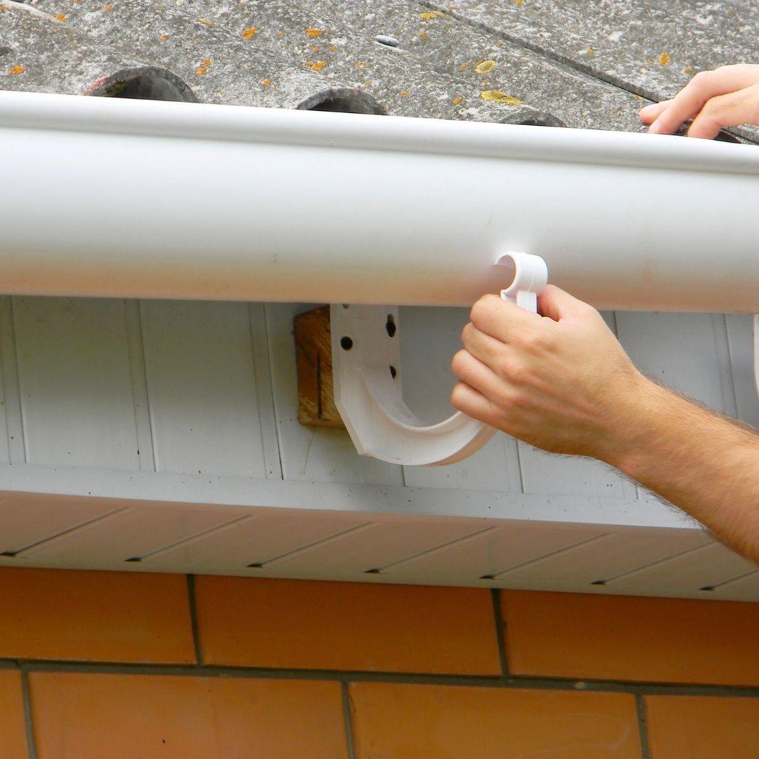Someone installing gutters.